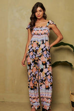 Load image into Gallery viewer, FLORAL BORDER SMOCKED BODICE RUFFLED JUMPSUIT: L / Black
