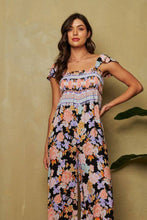 Load image into Gallery viewer, FLORAL BORDER SMOCKED BODICE RUFFLED JUMPSUIT: S / Black
