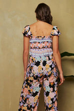 Load image into Gallery viewer, FLORAL BORDER SMOCKED BODICE RUFFLED JUMPSUIT: S / Black
